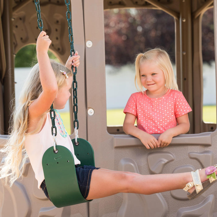 A young girl conversing with another child who is swinging at the Lifetime Adventure Tower Playset.