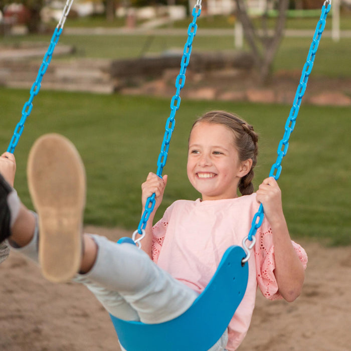 A child enjoying a swing on the Lifetime Adventure Tower Playset during sunset.