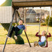 Two children smiling and swinging on the green belt swings of the Lifetime Adventure Tunnel Playset.