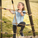 A girl climbing the cargo net of the Lifetime Adventure Tunnel Playset with focus on her enjoyment.