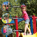 Detailed view of the Lifetime Big Stuff Deluxe Swing Set 91087, highlighting additional features such as cargo net, climbing wall, and fireman's pole.