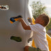 Child ascending gray climbing wall on the Lifetime Big Stuff Deluxe Swing Set, SKU 91087.