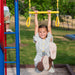 Child hanging from the yellow gym rings of the Lifetime Big Stuff Deluxe Swing Set 91087.