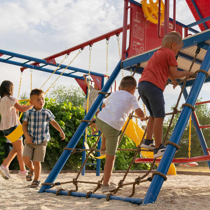 Children engage with various activities on the Lifetime Big Stuff Deluxe Swing Set, featuring primary colors, with two boys climbing a blue ladder and a girl in the background swinging.