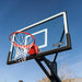 Angled view of the clear backboard and red rim of the Lifetime Mammoth 60-Inch Basketball Hoop.
