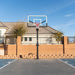 The Lifetime Mammoth 60-Inch Basketball Hoop captured at sunset with a residential backdrop.