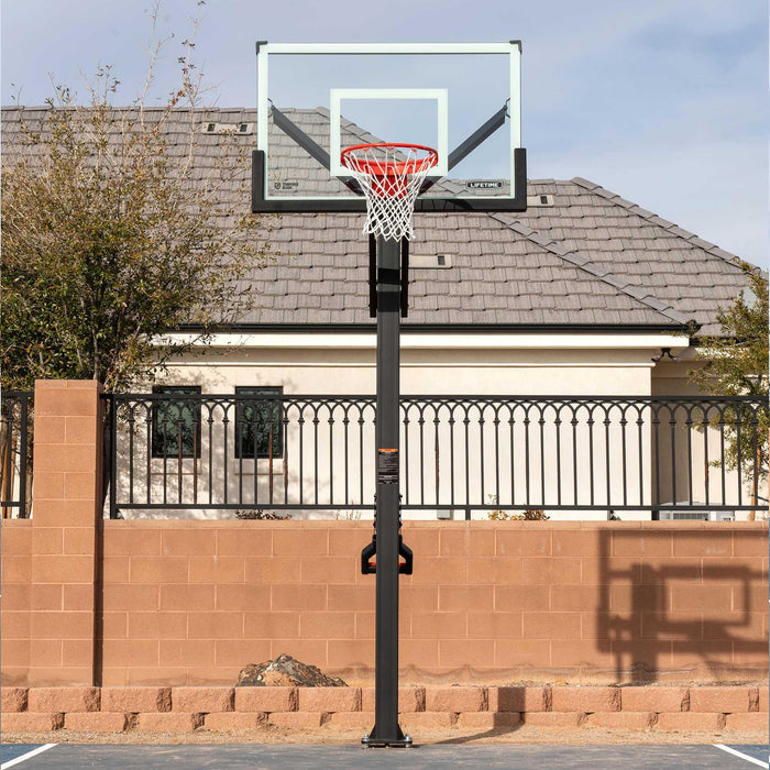 Lifetime Mammoth Basketball Hoop in full view with a residential fence in the background.