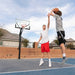 Two players in an offensive and defensive position at the Lifetime Mammoth Basketball Hoop.