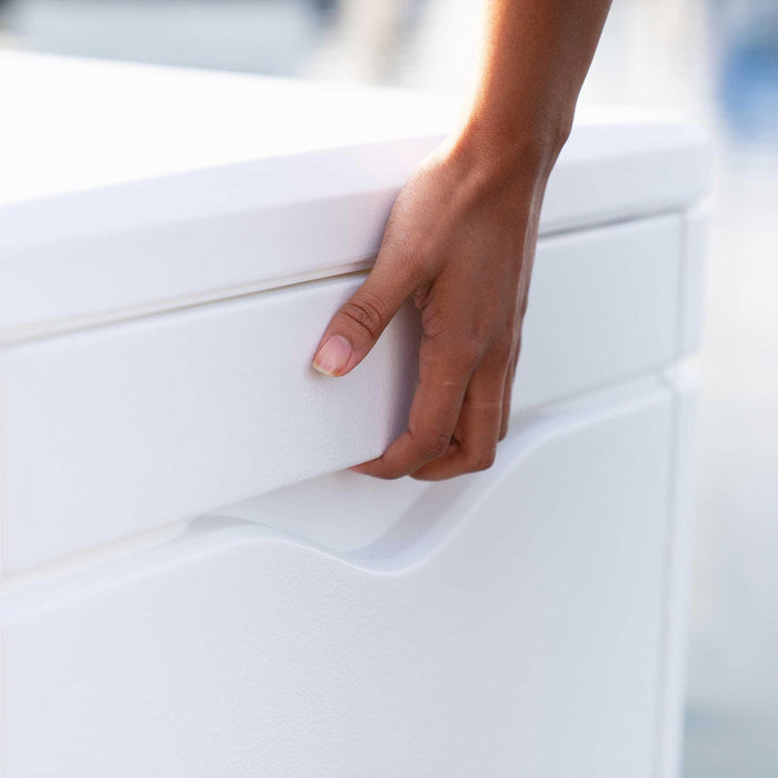 Close-up of a person's hand opening the Lifetime Marine Dock Box, model 60348, highlighting the handle.