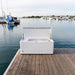 White Lifetime Marine Dock Box, model 60348, closed and placed on a wooden dock with marina and boats in the background.