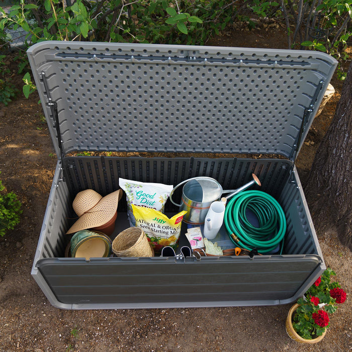 Example usage of the Lifetime Modern Outdoor Storage Deck Box, showing various items stored inside with the lid open in an outdoor setting.