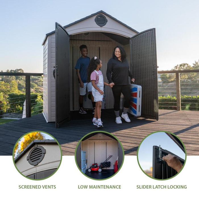A family standing at the entrance of a Lifetime 8 ft x 5 ft Outdoor Storage Shed showcasing screened vents and a slider latch locking mechanism.