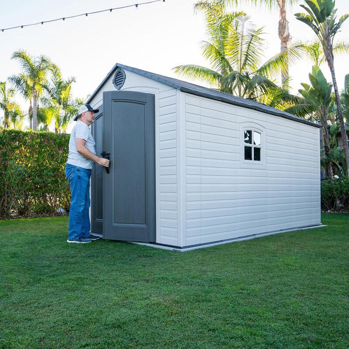 Side perspective of the Lifetime 8 ft x 12.5 ft Outdoor Storage Shed with the door open, revealing the spacious entryway.