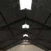 Interior view of the roof structure of the Lifetime 8 ft x 12.5 ft Outdoor Storage Shed, with a skylight visible.