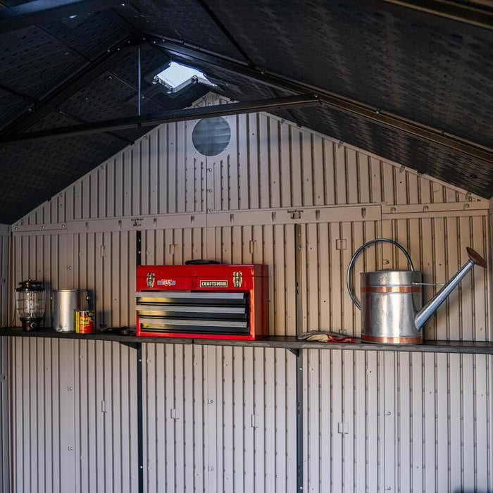 Interior wall of Lifetime 8 Ft. x 15 Ft. Outdoor Storage Shed with tools and a red toolbox on shelves.