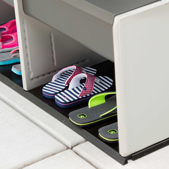 Close-up detail of flip-flops stored in the lower compartment of the Lifetime storage locker.