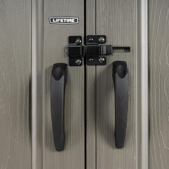 Close-up of the double door handles on a Lifetime storage shed, featuring a black slider latch locking system.