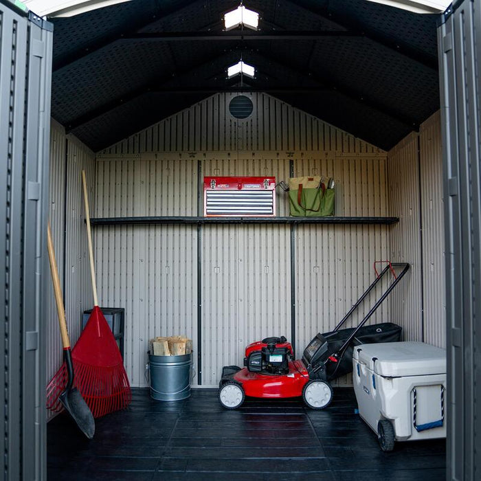 Interior view of Lifetime 8 ft x 7.5 ft Outdoor Storage Shed showing organized tools, a lawn mower, and adjustable shelves.