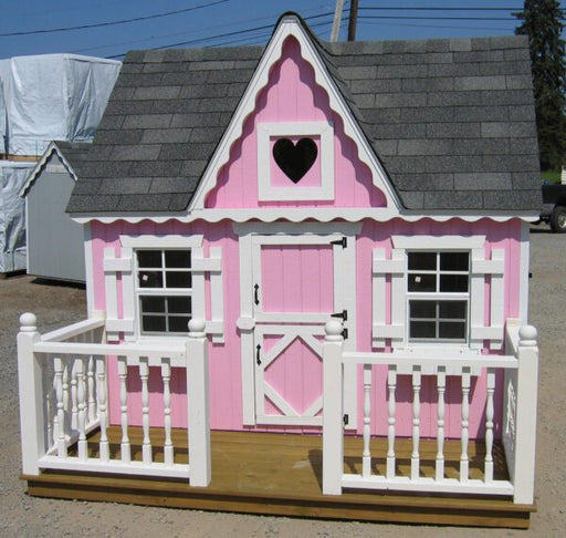 Close-up front view of the delightful Victorian cottage playhouse.