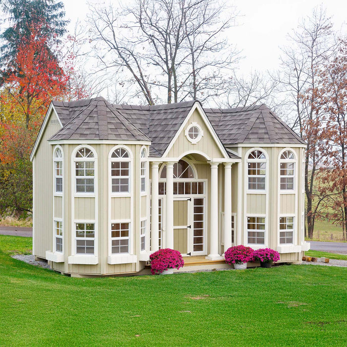 Little Cottage Company's Grand Mansion playhouse with a portico front, set against a natural landscape.