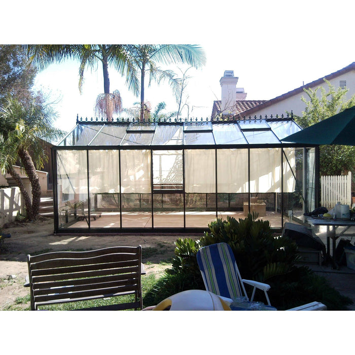 Luxurious Exaco Janssens Royal Victorian VI 46 Greenhouse set in a suburban backyard, integrating seamlessly with the residential landscape and offering a private oasis for horticulture.