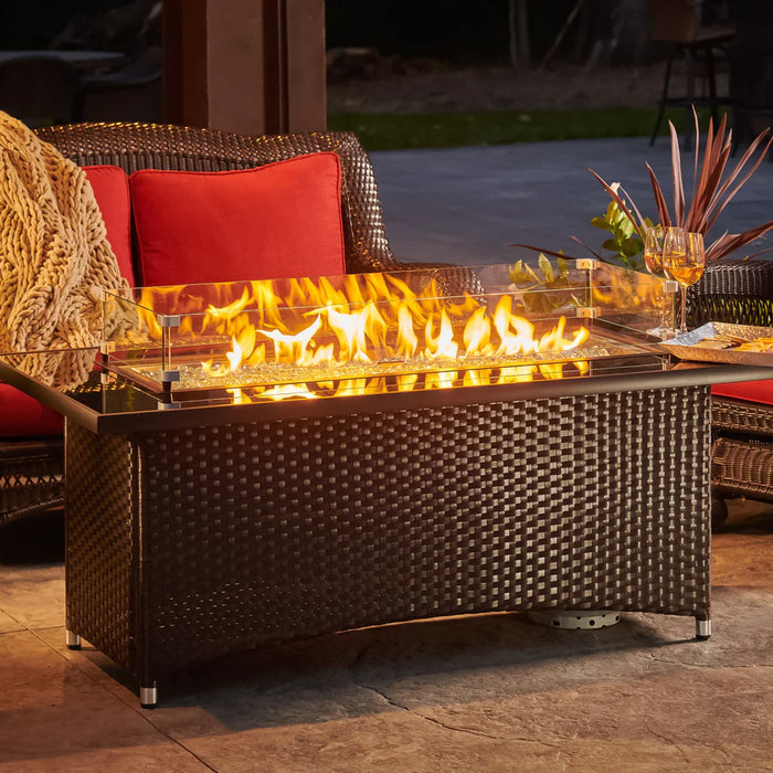 A detailed view of the Fire Pit Table's glass flame guard and the warm glow of the fire.