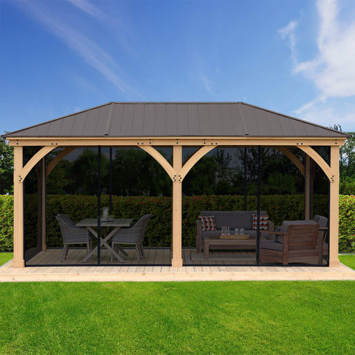  A full view of a stylish outdoor wooden gazebo with a mosquito mesh kit installed, set in a beautifully landscaped yard, demonstrating a perfect blend of functionality and design for outdoor living spaces.