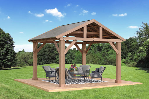 Fully assembled 14x12 Yardistry Meridian Pavilion in a garden setting with outdoor furniture under its shelter. 