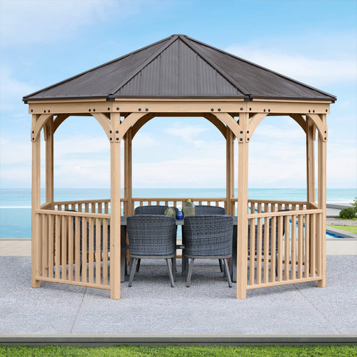 Fully assembled Yardistry 12 ft Meridian Octagon Gazebo in a garden setting with outdoor furniture under its shelter.