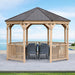Fully assembled Yardistry 12 ft Meridian Octagon Gazebo in a garden setting with outdoor furniture under its shelter.