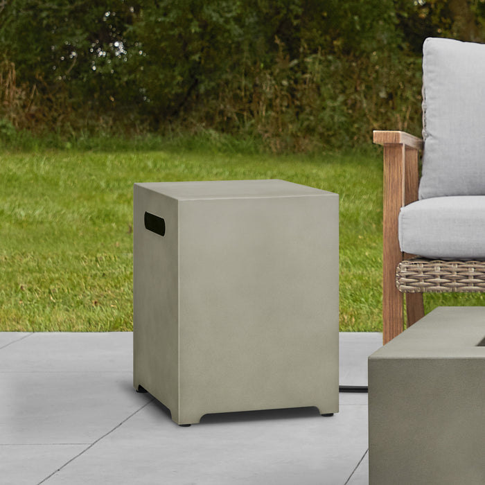 Real Flame Metal Propane Tank Cover in a natural outdoor setting, providing a sleek and functional utility with white cushioned chair