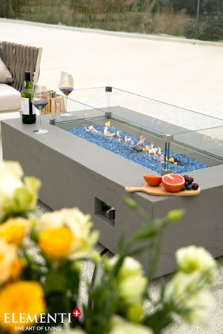 Meteora Rectangular Concrete Fire Pit Table with wine and fruits