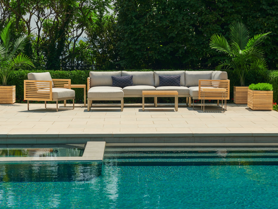 Monterey	Furniture Set	featuring a sectional sofa with cushions by the poolside with lush greenery