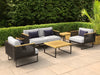 Monterey	Furniture Set	with cushions on a patio surrounded by greenery