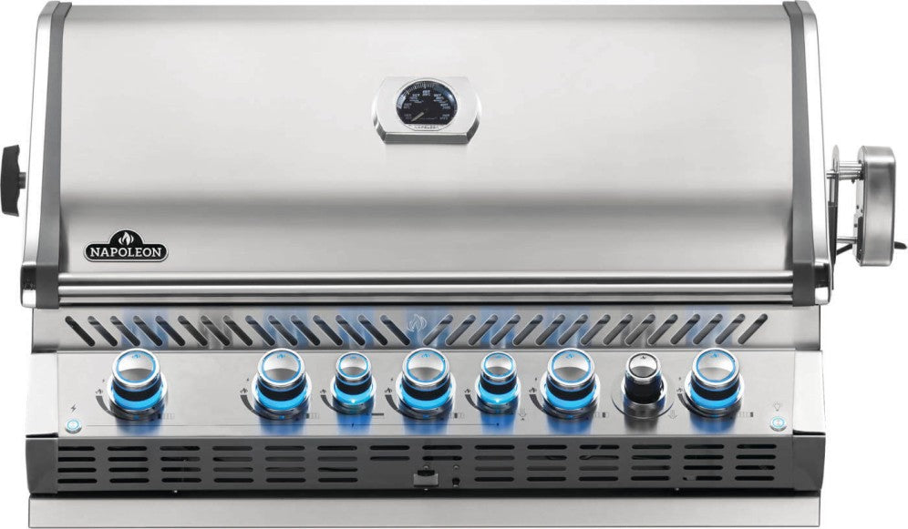 Front view of Napoleon Grills Built-In Prestige PRO™ 665 RB 7-Burner Gas Grill Head with illuminated control knobs and a closed lid featuring a temperature gauge.