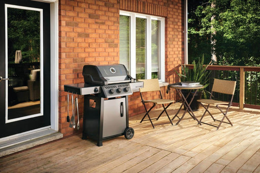 Napoleon Grills Freestyle 365 3-Burner Gas Grill positioned on a wooden deck with outdoor furniture.