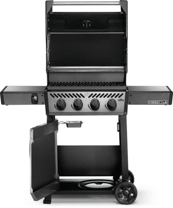 The Napoleon Grills Freestyle 425 4-Burner Gas Grill in an atmospheric setting with soft lighting.