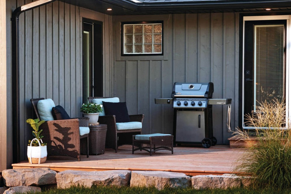 A stylish outdoor patio setup featuring the Napoleon Grills Freestyle 425 4-Burner Gas Grill.