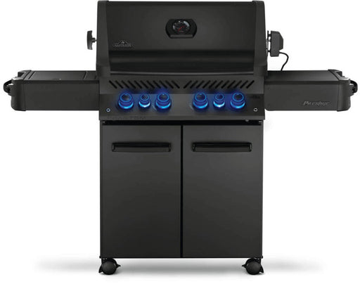 Front view of Napoleon Grills Phantom Prestige 500 RSIB 6-burner grill with side tables and lid closed, showcasing illuminated control knobs.