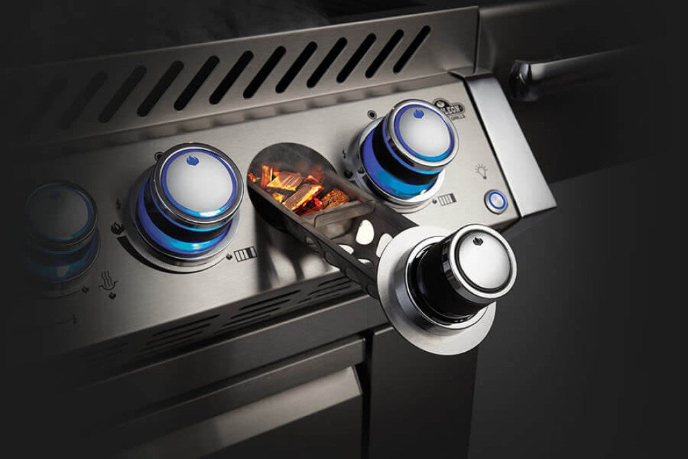 Detailed image of the integrated wood chip smoker tray next to the control knobs of the Napoleon Grills Built-In Prestige PRO™ 825 RBI.