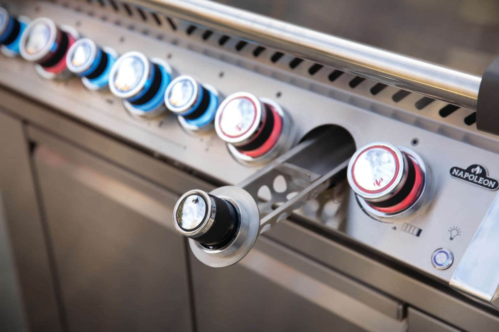 Close-up of the smoker tube feature on the Napoleon Grills Prestige PRO™ 665 RSIB Grill with visible flame.