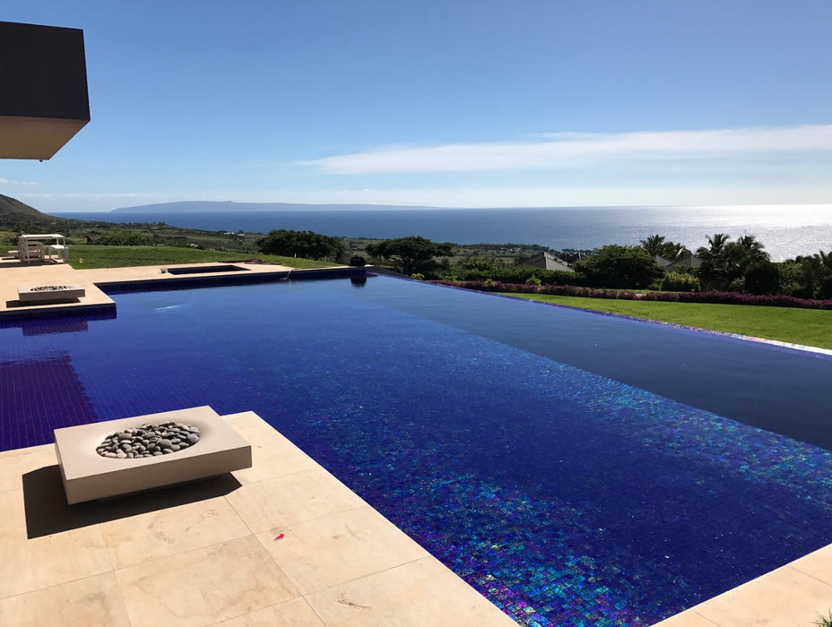 Overlooking the ocean, the Solus Decor Halo Low 60K BTU Fire Pit enhances the luxury of an infinity pool with its elegant design and comforting flames.
