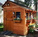 Quaint Outdoor Living Today 8x8 Sunshed Garden Shed adorned with colorful flower boxes and traditional lanterns, creating a picturesque garden nook