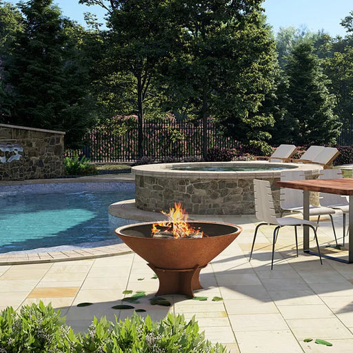 Arteflame Classic fire bowl in a 40-inch size enhancing an outdoor poolside patio.