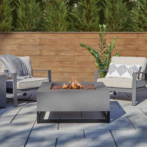Elegant Patio Setup Featuring the Real Flame Blake Natural Gas Fire Pit Table with 2 chairs and fire pit C966LP-WSLT