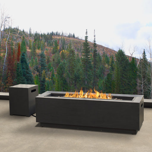Outdoor setting featuring a lit Real Flame Lanesboro gas fire pit table with natural backdrop, model CT0003LP-SW4
