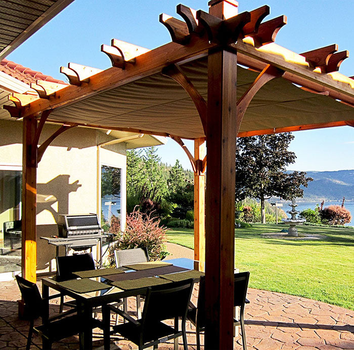 Outdoor Living Today Pergola with Retractable Canopy 8×10 overlooking a scenic lake, perfect for outdoor dining.