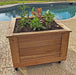 Outdoor Living Today Self Watering Planter 2x2 with various greenery planted in it placed beside the pool