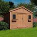 rendered image of the Outdoor Living Today Space Master Storage Shed with Double Doors on a grassy backyard with closed doors