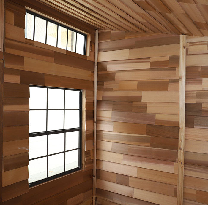 Inside the Outdoor Living Today Studio 12x8, the spacious interior boasts a varied wood paneling design